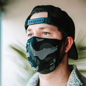 30X Mask, gray camo, ear loop mask, worn by a young man