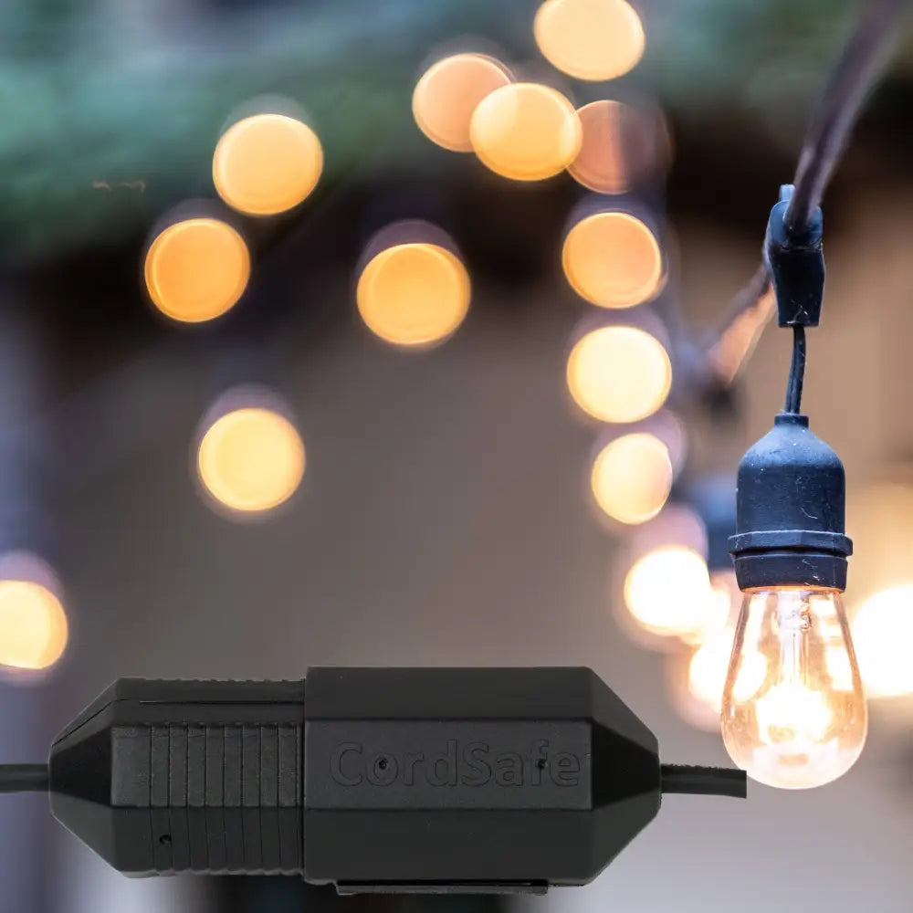 Black Cordsafe outdoor string light connector with glowing amber bulb