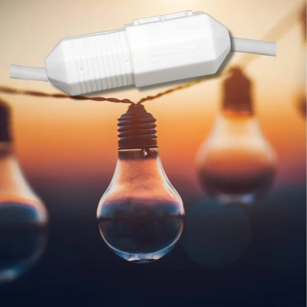 White plastic string light connector with ribbed texture and integrated cord