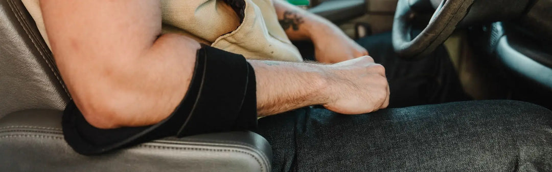 Black LBO Armor elastic arm brace on drivers forearm in car