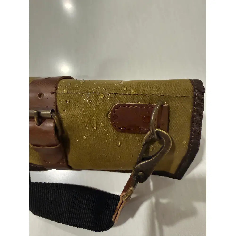 Olive green blade guard waxed canvas knife roll bag with brown leather accents and brass clasp with dedicated knife pockets