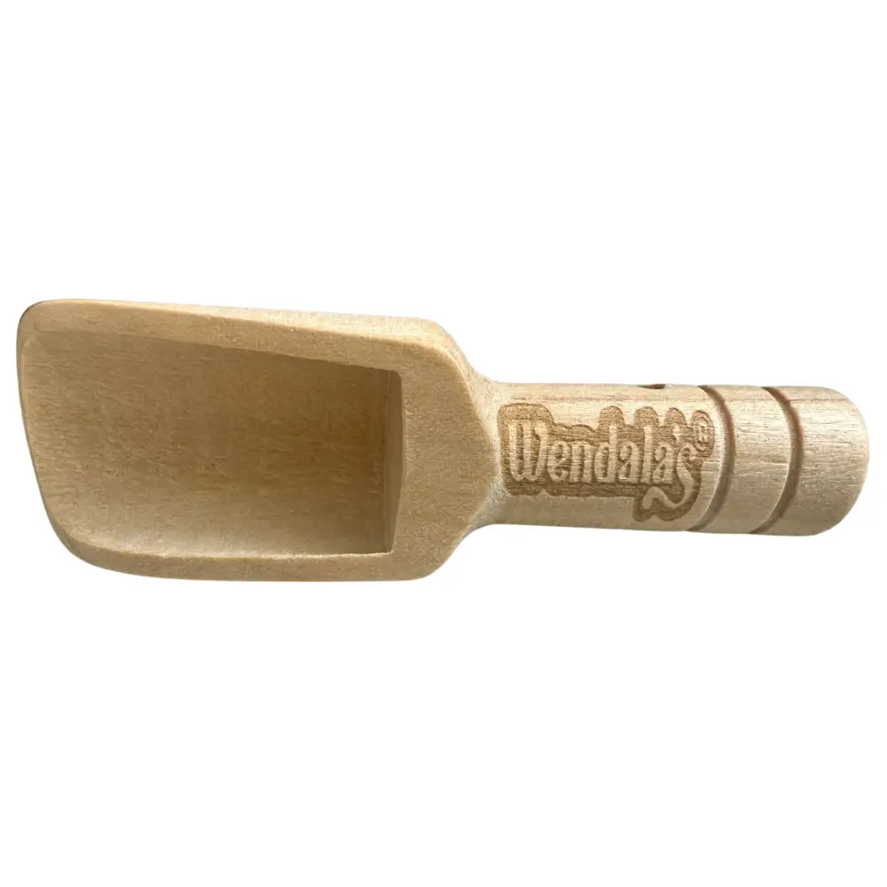 Light-colored wooden scoop with wendalas®️ engraving for hand scrubs in the coastal hand scrub bundle to add water