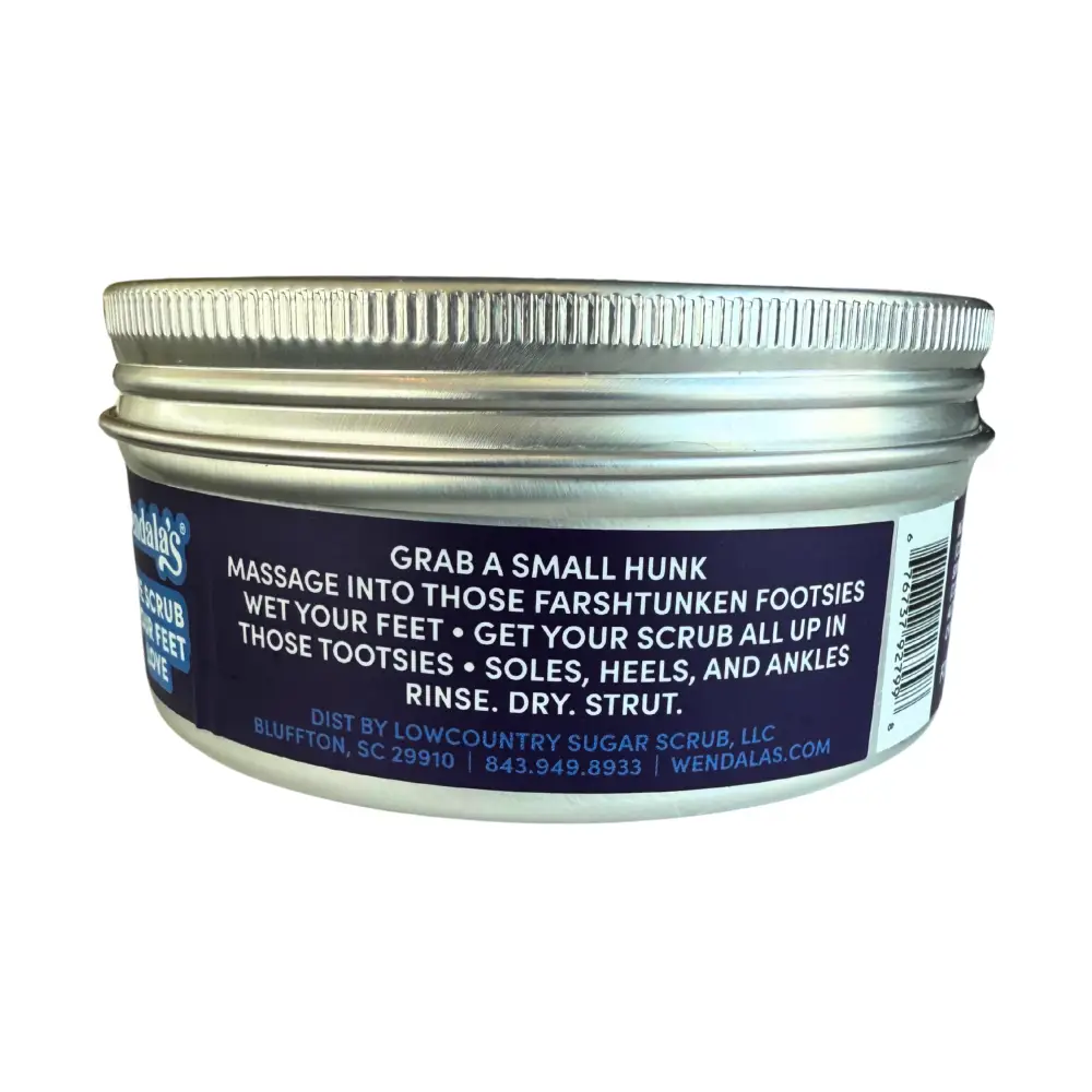A silver metal jar with a ribbed lid labeled wendalas eucalyptus lavender foot scrub with eucalyptus essential oils