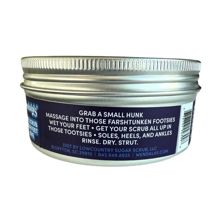 A silver metal jar with a ribbed lid labeled wendalas eucalyptus lavender foot scrub with eucalyptus essential oils