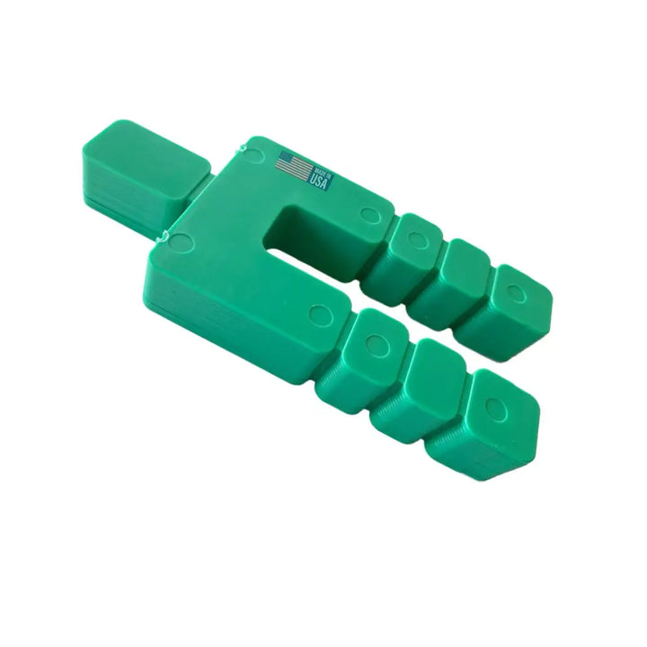 Green u-shaped plastic glazelock shim with two rows of four square segments for stacking and spacing