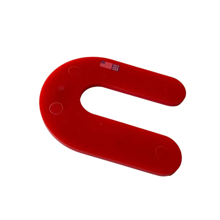 Red u-shaped plastic glazelock shims with three circular indentations and made in usa label for horseshoe shims