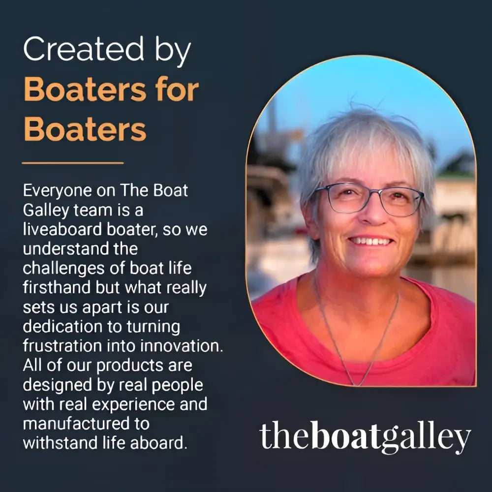A smiling woman with short gray hair wearing glasses and coral top holding a handy VHF radio cheat reference sheet