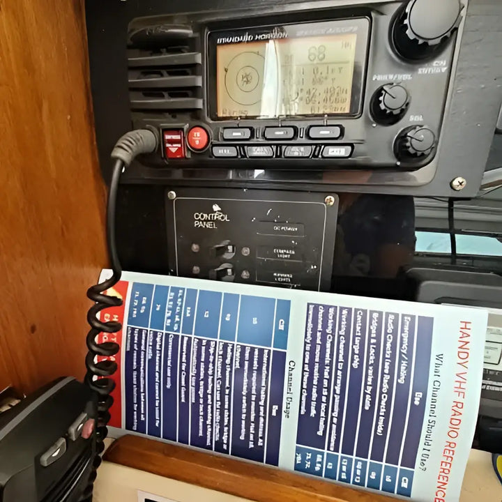 Black handheld vhf radio with digital display and control knobs for marine use in handy vhf reference radio cheat sheet