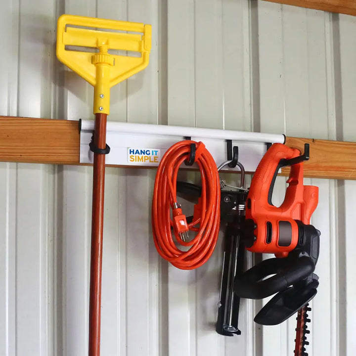 Yellow plastic handled mop with brown wooden pole hung on white hang it simple universal storage hanger hooks