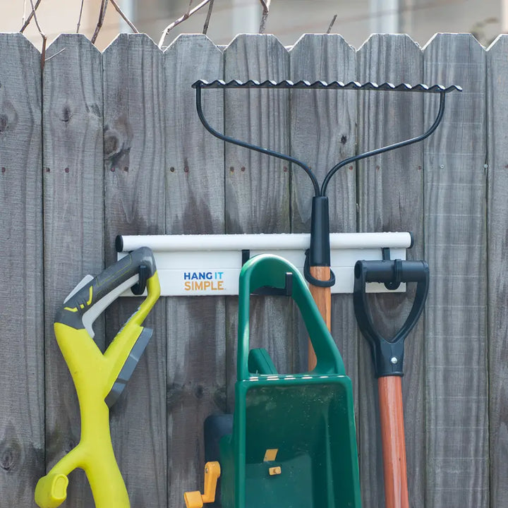 White hang it simple garden tool organizer with black universal storage hanger hooks holding rake trowel and pruner