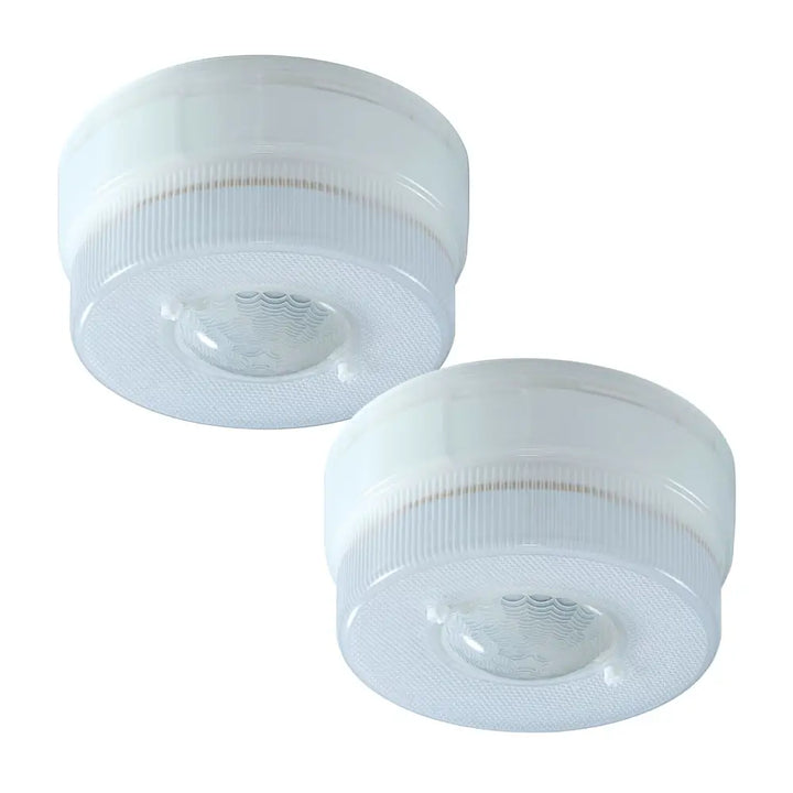 Two white battery powered motion light ceiling lights with textured plastic casing and central lens by iq america