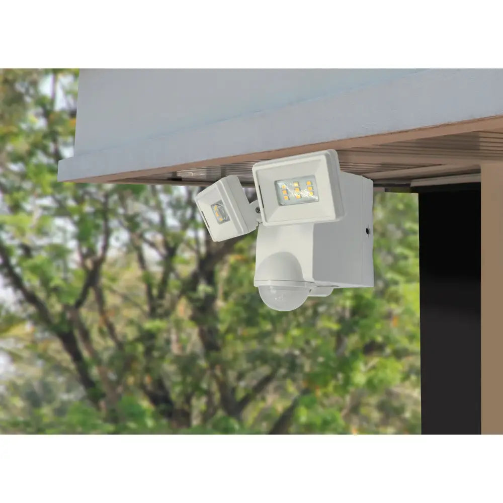 White iq america led motion security flood light with dual heads and spherical sensor battery powered motion light eave mount