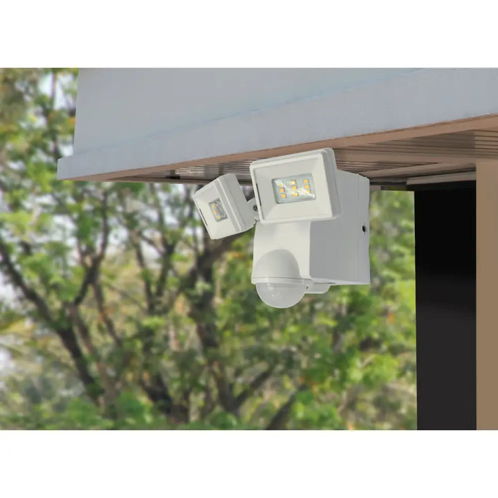 White iq america led motion security flood light with dual heads and spherical sensor battery powered motion light eave mount