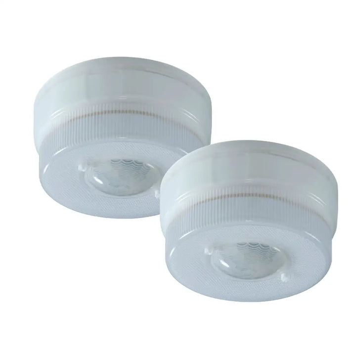 Two white circular IQ America battery operated motion sensor led ceiling lights with frosted plastic casings and ribbed edges