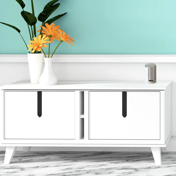 White mid-century modern sideboard with black vertical handles and tapered legs featuring iq america battery powered wireless doorbell chime kit