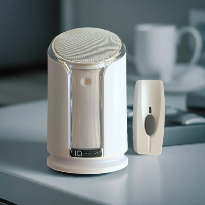 White iq america wireless portable doorbell chime kit with sleek cylindrical speaker and rectangular battery powered button