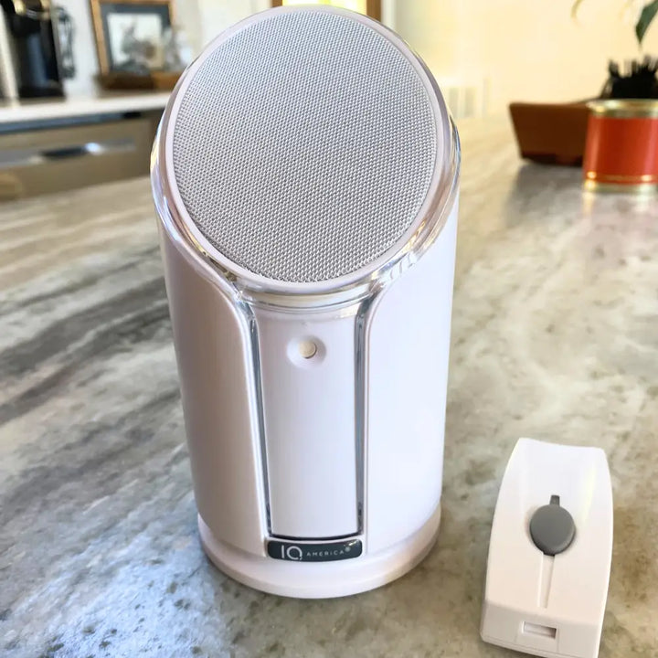 White cylindrical iq america powered wireless doorbell chime with silver mesh grille and clear plastic trim battery powered wireless