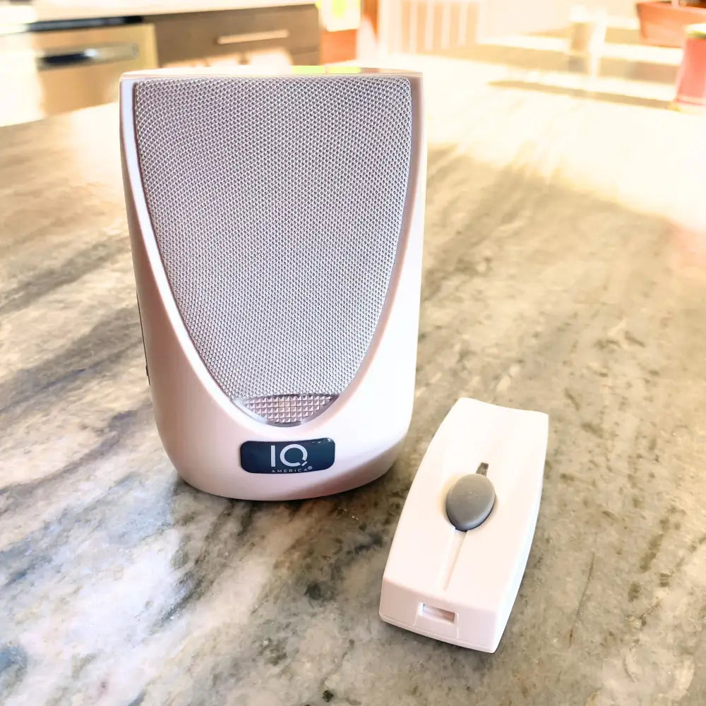 White iq america wireless portable doorbell chime kit with silver mesh speaker and matching battery powered wireless remote control