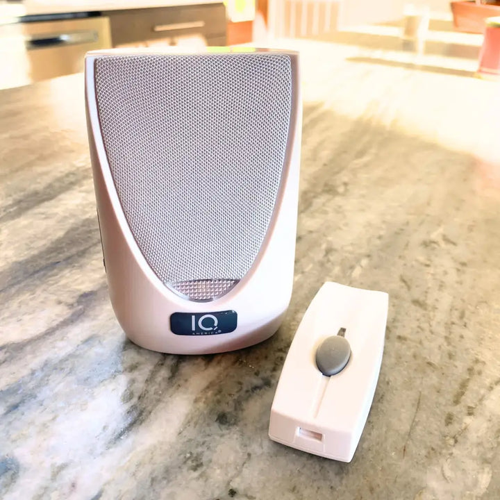 White iq america wireless portable doorbell chime kit with silver mesh speaker and matching battery powered wireless remote control