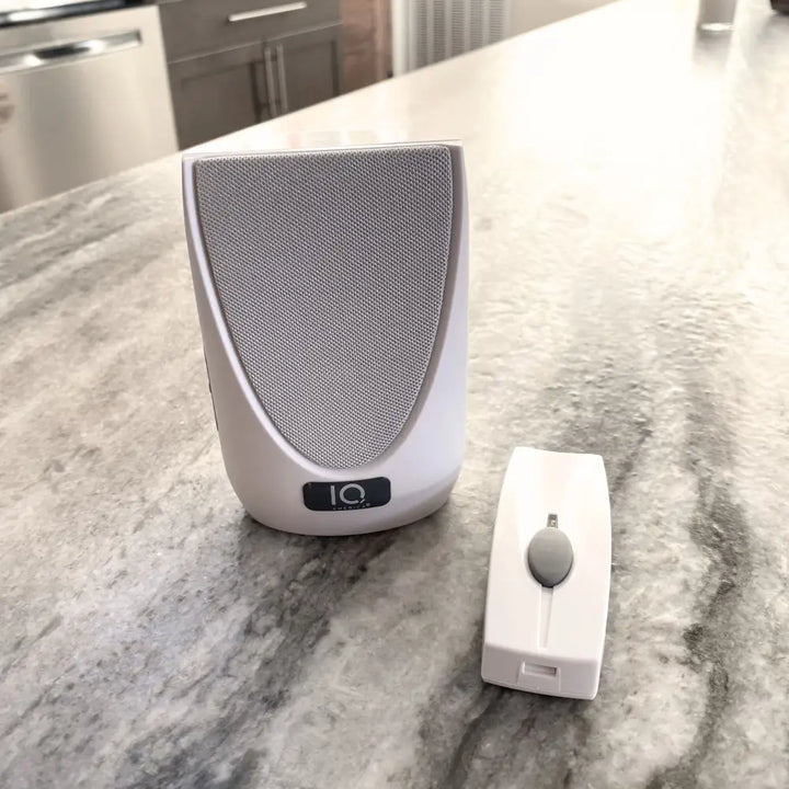 White io brand wireless portable door bell system with sleek white speaker and battery powered wireless chime remote control