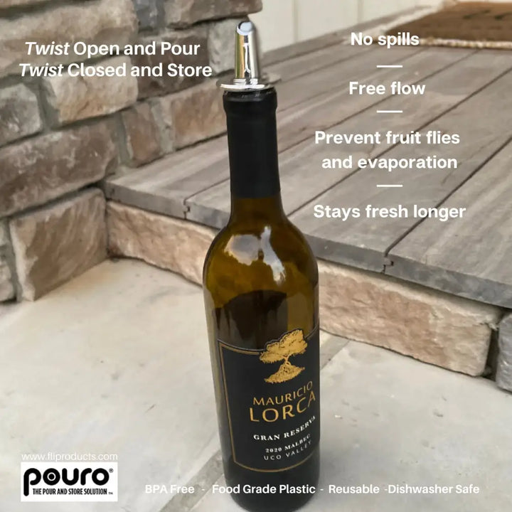 A sleek dark green glass wine bottle with a black label and a silver pouro chrome bottle pourer spout