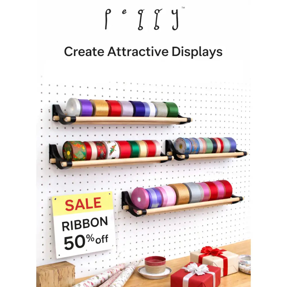 Professional pegboard roll storage with wooden shelf, black metal brackets, colorful ribbon spools