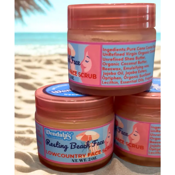 Three stacked jars of wendalas resting beach facial scrub with peach lids featuring a woman under umbrella design