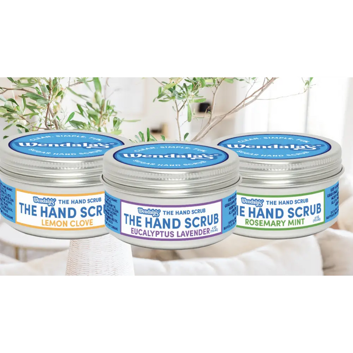 Three silver-topped jars of wendala’s hand scrub bundle in lemon clove eucalyptus lavender and rosemary mint scents
