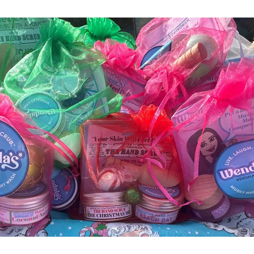 Pink mesh drawstring bags filled with colorful hand scrubs and lotions from wendala’s essential hand scrub bundle