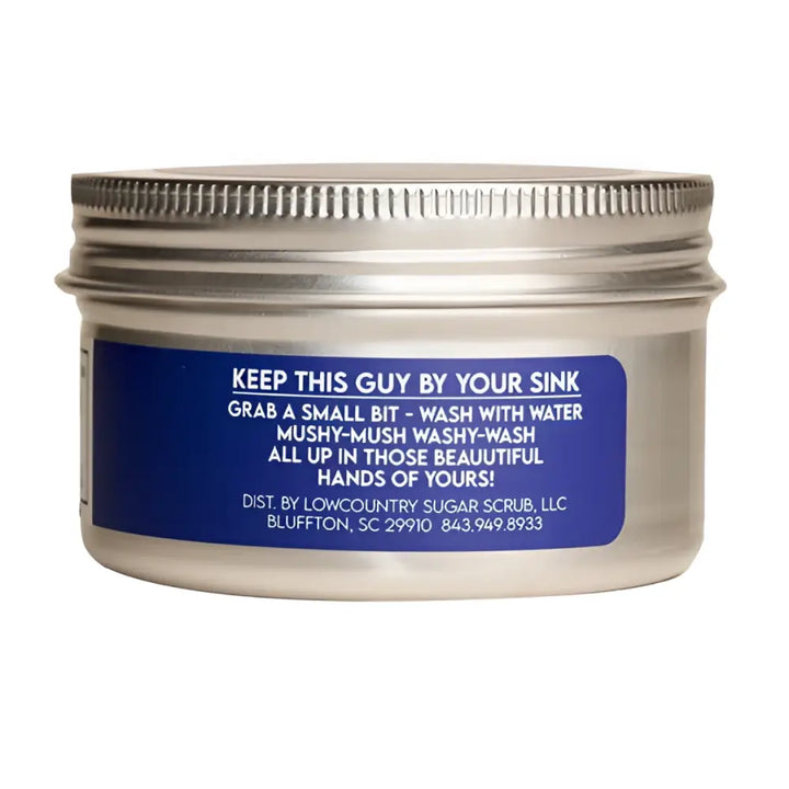 Silver metal jar of the hand scrub coconut peach with organic coconut sugar scrub label for use by your sink