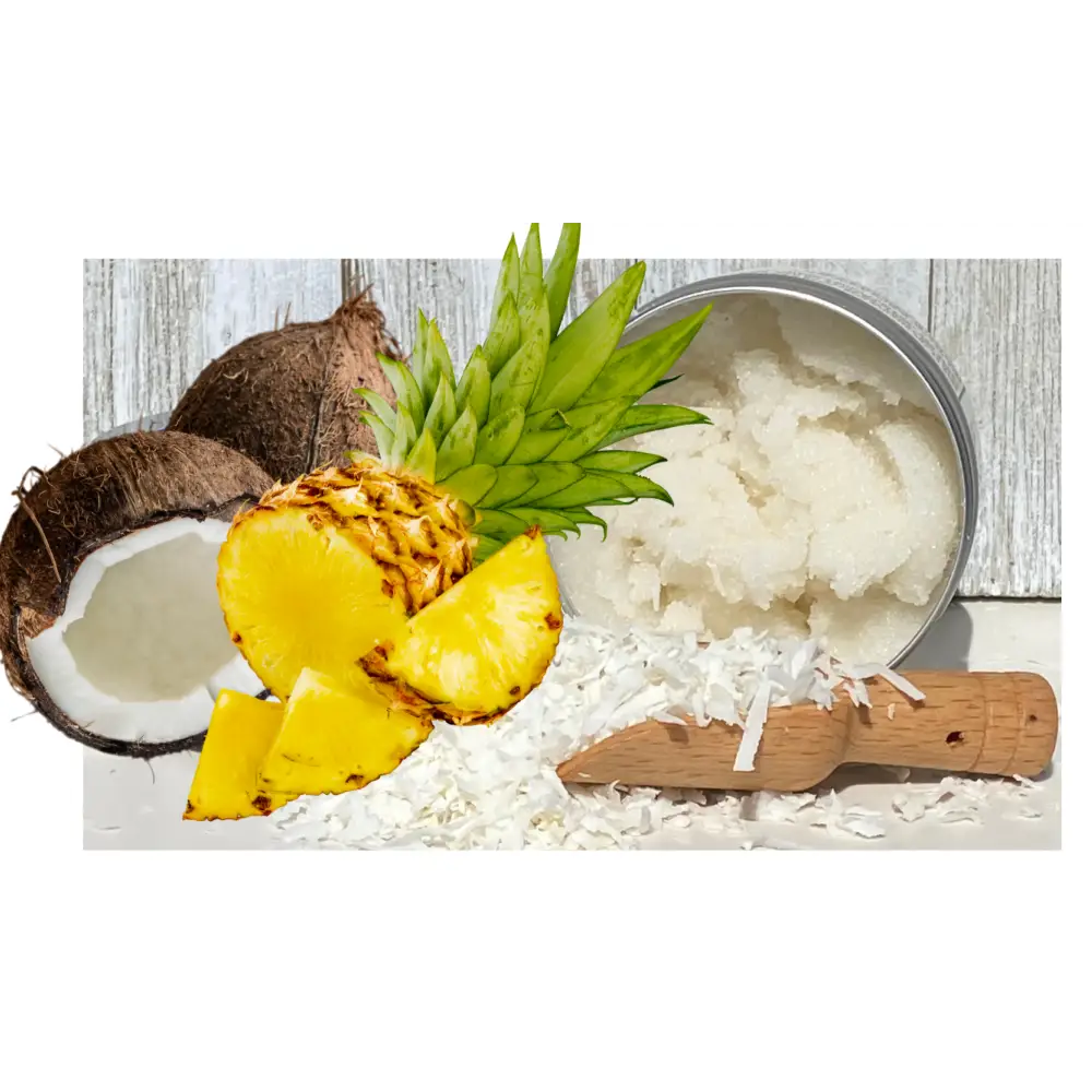 A round metal tin of white coconut oil hand scrub surrounded by pineapple slices and whole coconut for pina colada care