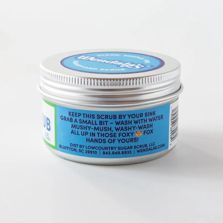 Silver tin container of wendalas hand scrub with rosemary mint scent featuring blue and white label for clear skin