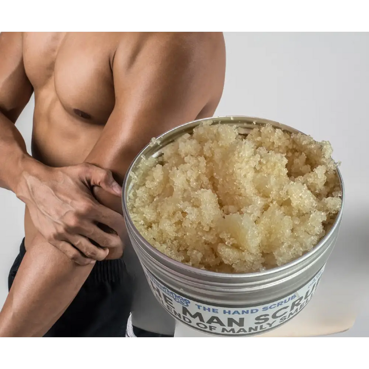 A metallic container of the man scrub coarse beige granules with shea butter and organic coconut for manly scents