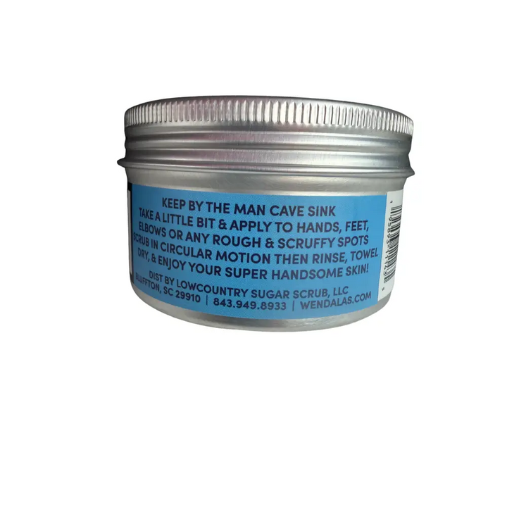 Silver metal jar with blue label showing white text and barcode of the man scrub with shea butter and organic coconut