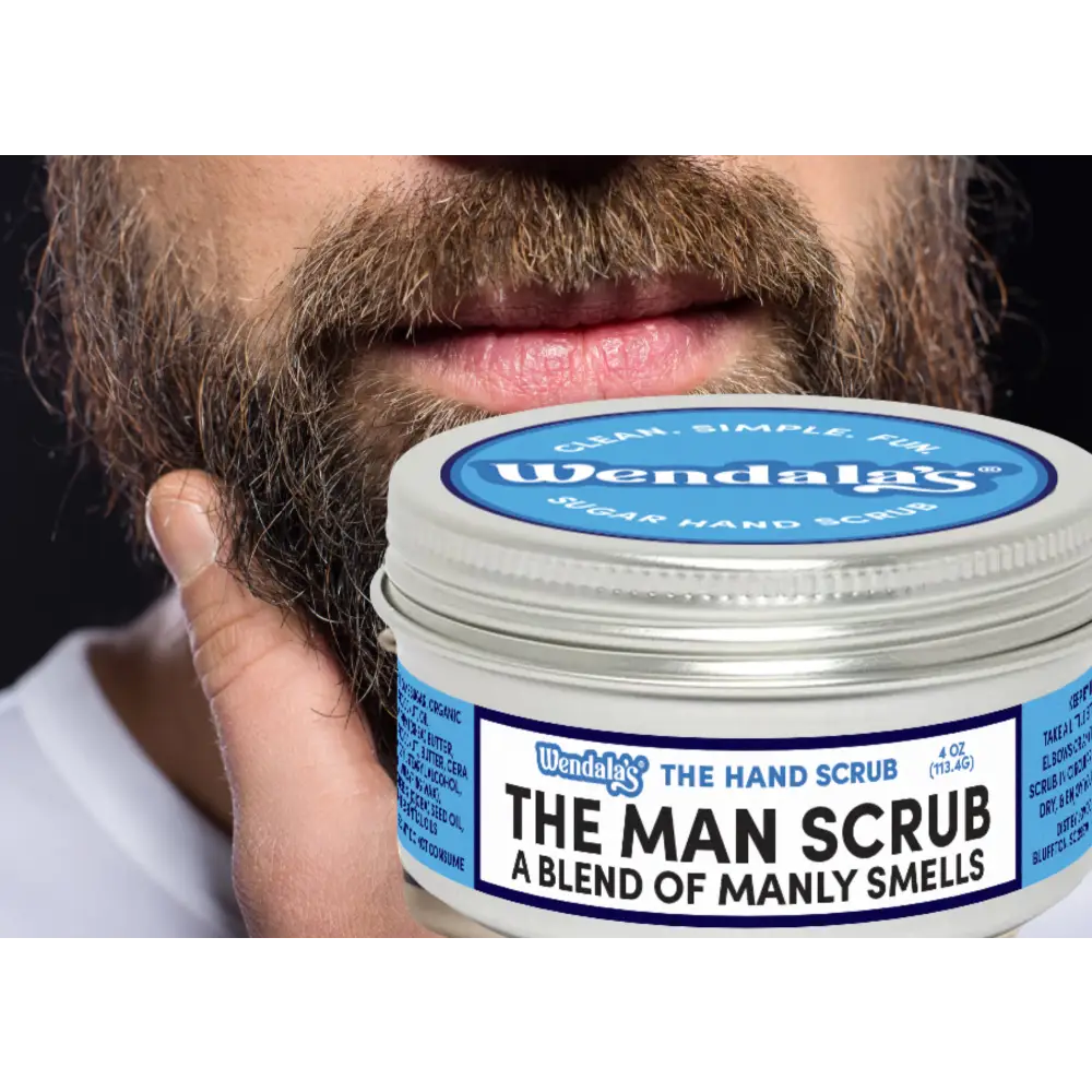 A silver-lidded jar of wendalas the man scrub with shea butter and organic coconut for a blend of manly smells