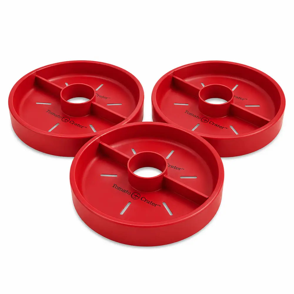 Red plastic tomato crater trays with segmented compartments and central hole for root-zone watering and conserving water