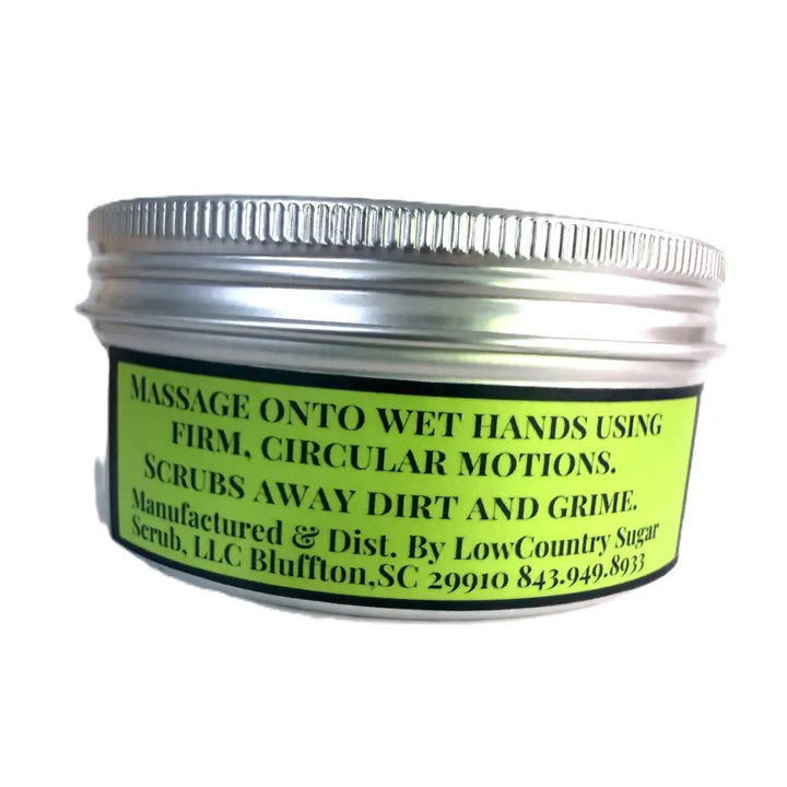 A small round metal jar of wendalas dirtx hand scrub with a ribbed silver lid and lime green label showing usage instructions