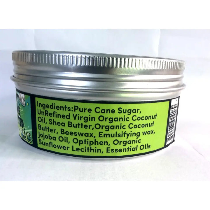 A silver metal jar of Wendalas dirtx hand scrub with a ribbed lid and bright green label listing natural ingredients