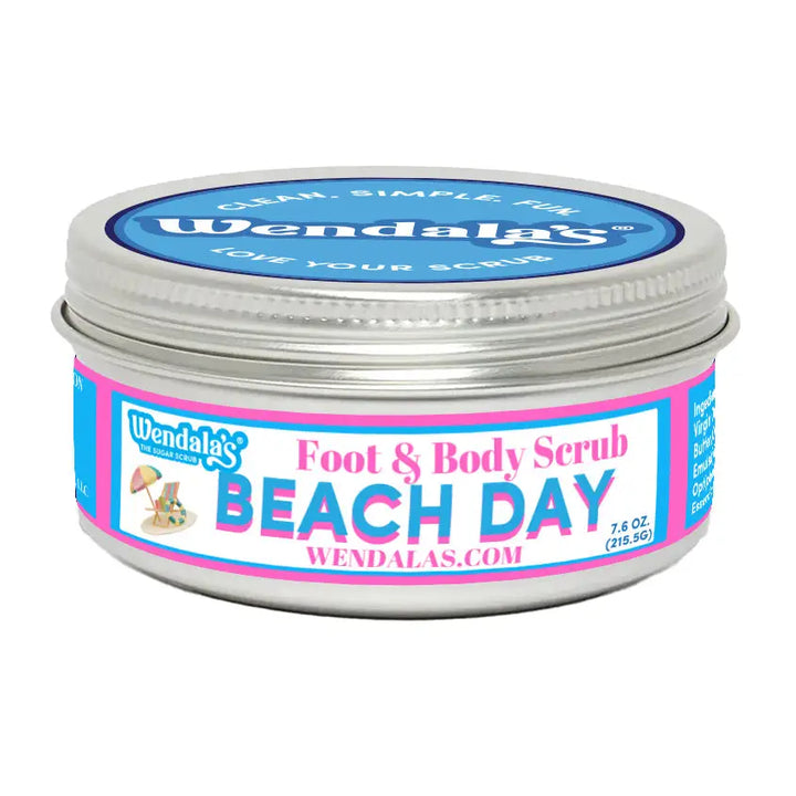 A silver metal jar of Wendala’s foot and body scrub beach day with unrefined shea butter and organic coconut butter label