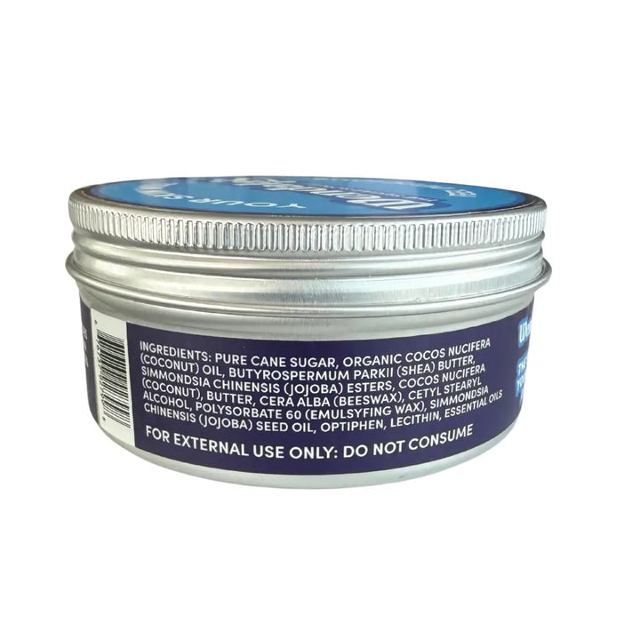 Silver metal jar with blue lid and dark purple label for Wendalas foot scrub with eucalyptus essential oils and jojoba beads