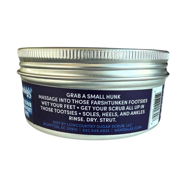 A silver metal jar labeled Wendala’s containing eucalyptus lavender foot scrub with jojoba beads and ribbed lid