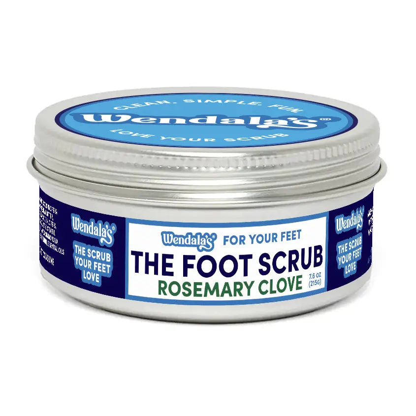 Wendalas rosemary clove foot scrub in a silver tin with blue and white labeling featuring organic coconut butter and jojoba beads