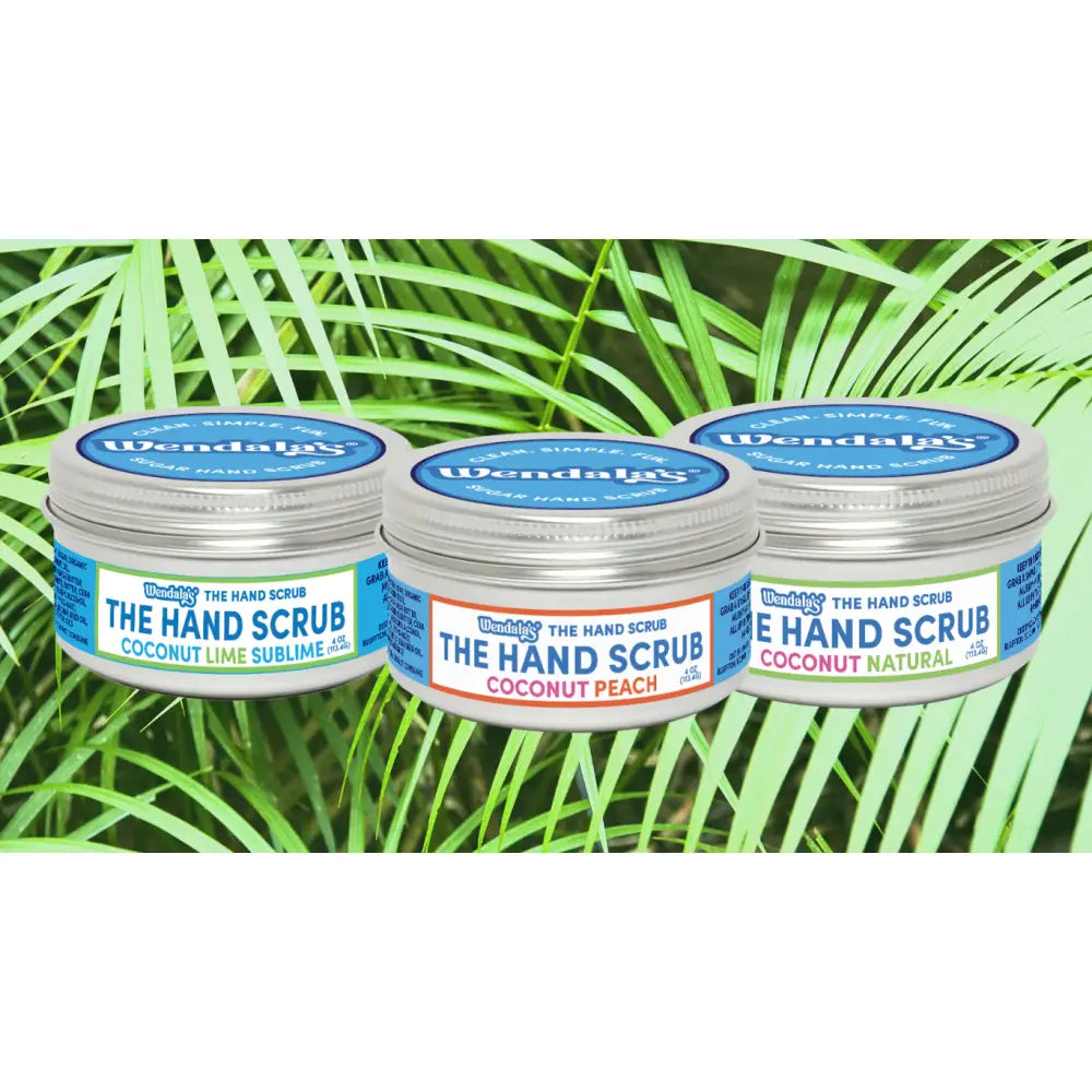 Three small round metal jars of wendala’s®️ peach me a coconut hand scrub collection with shea butter flavors