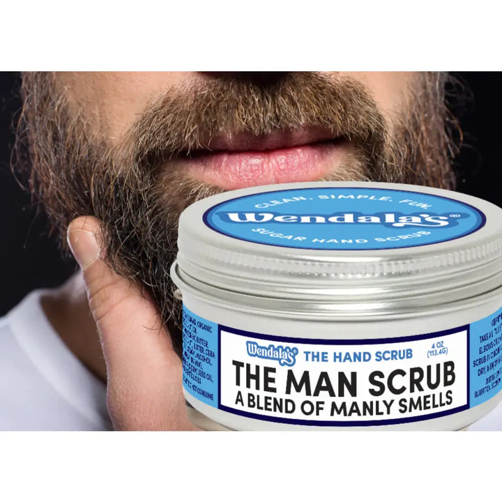A silver-lidded jar of wendala’s man scrub with organic coconut oil and raw sugar for exfoliating manly scents