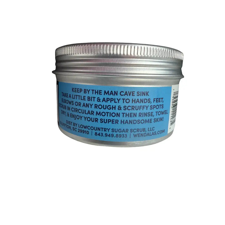 Silver metal jar with blue label showing white text and barcode on wendala’s man scrub with organic coconut oil and raw sugar