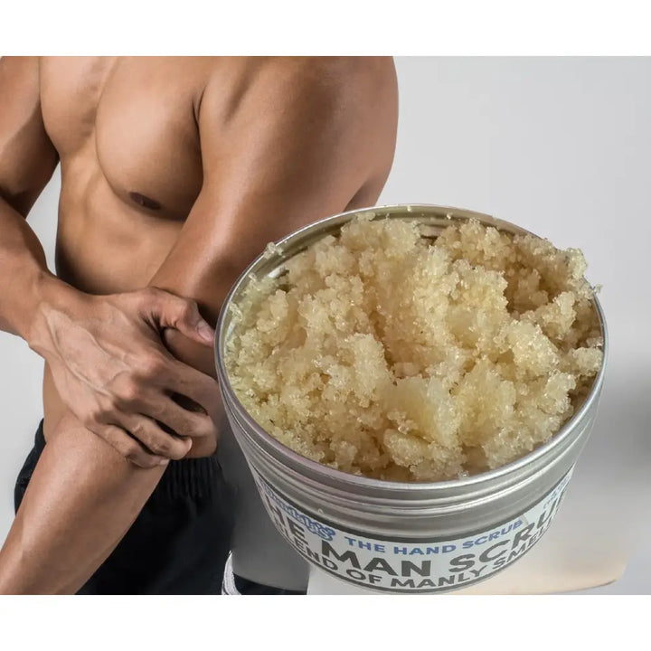 A metallic container of Wendala’s man scrub with coarse translucent beige raw sugar and organic coconut oil blend