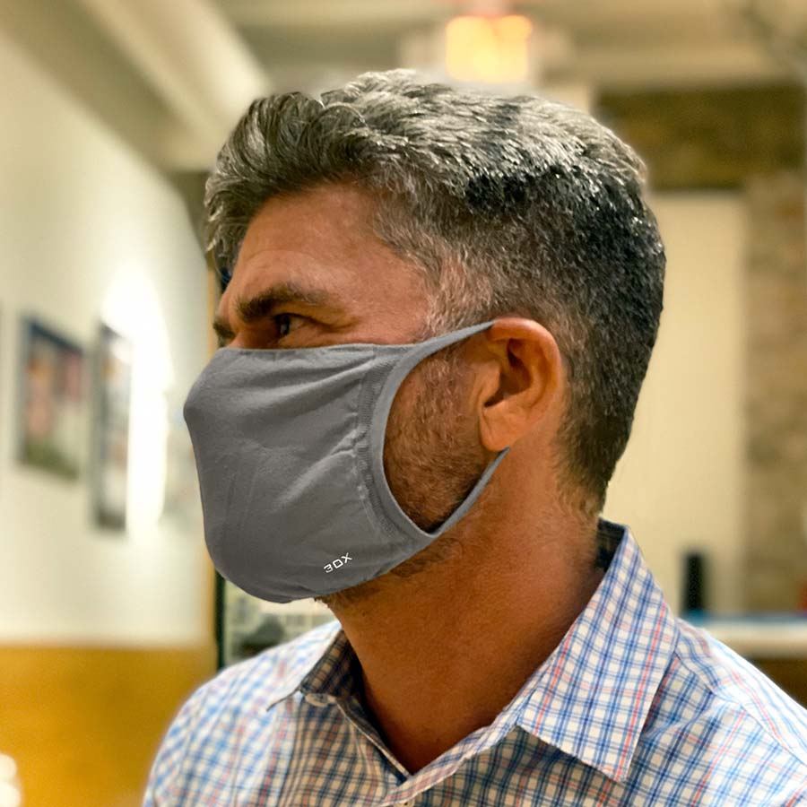 30X Mask, gray ear loop mask, worn by a man showing a side profile