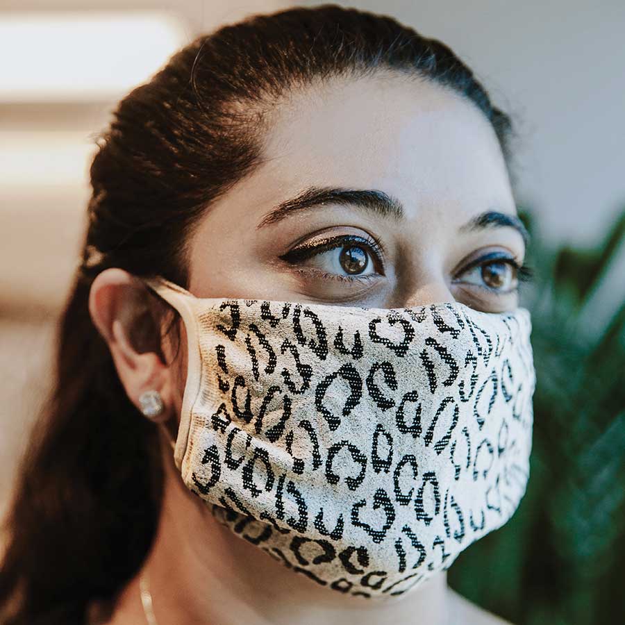 30X Mask, Créme Leopard ear loop mask, worn by a young woman