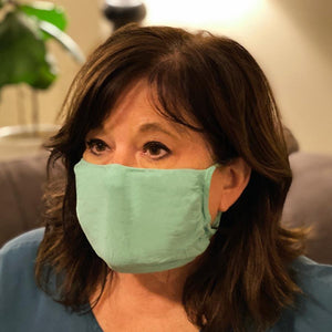 
            
                Load image into Gallery viewer, 30X Mask, scrub green ear loop mask, worn by a woman in scrubs
            
        
