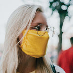 30X Mask, Mellow Yellow ear loop mask, worn by a young woman in sunglasses